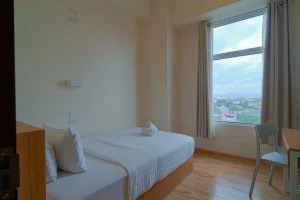 MySpace Hotel room featuring a cozy workspace, wide windows with city view, and comfortable bed setup ideal for both business and leisure travelers.