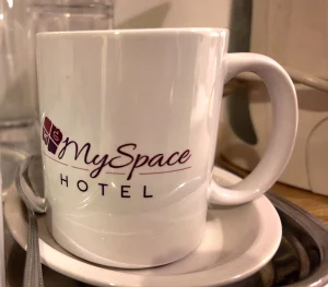 MySpace Hotel branded mug with saucer, perfect for enjoying complimentary in-room coffee or tea.
