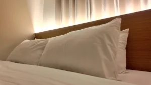 Comfortable bed with pillows at MySpace Hotel.