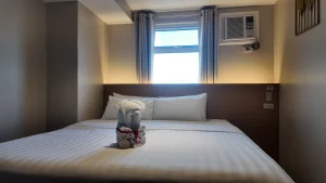 MySpace Hotel cozy standard room in Taguig with towel art and clean minimalist design.