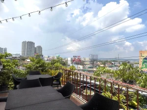 MySpace Hotel rooftop view of BGC skyline with outdoor seating and garden ambiance.