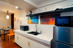 Fully equipped kitchenette at MySpace Windsor featuring a sink, fridge, microwave, and dining table for a comfortable extended stay.